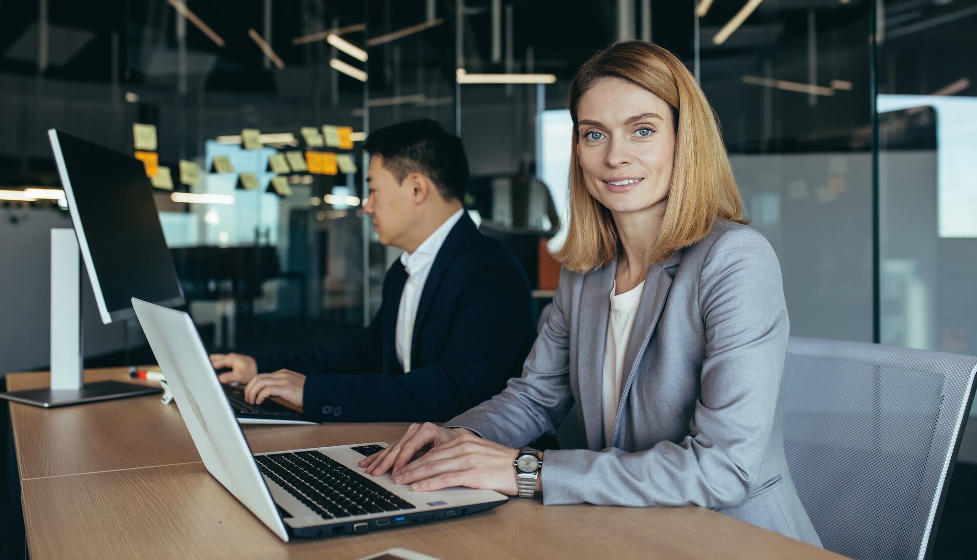 Portrait of successful woman, business team member, business woman looking at camera