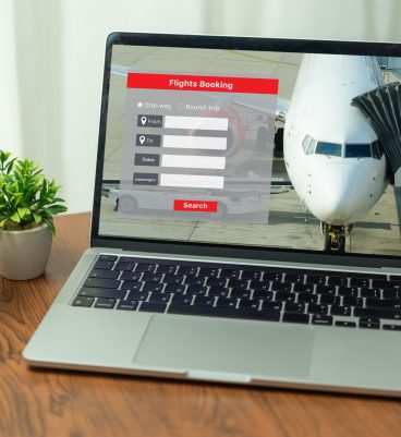 search Online booking plane ticket vacation on laptop. booking flight travel holidays online.